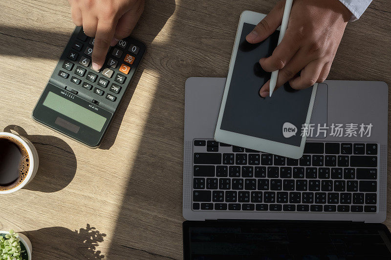 businessman using a calculator top view, calculating user expenses, budgeting, and loan accountingÂ